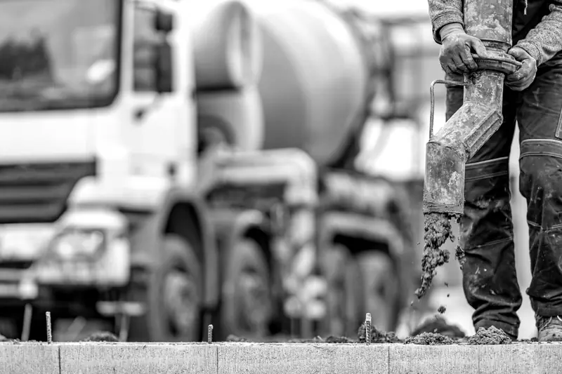 Conventional drum mixer truck pouring concrete from a chute